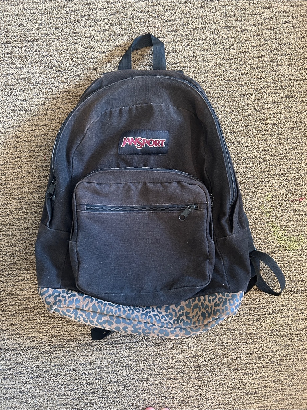 Brown Jansport back pack with a cheetah print suede bottom
